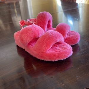 These are two pink fluffy comfy slippers from UGG!